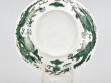 an image of a green and white plate on a stand