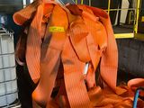 a pile of orange safety gear sitting on the floor