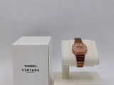 a close up of a watch on a display stand next to a box