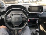 a man sitting in the driver ' s seat of a car