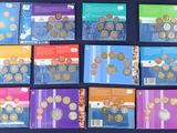 several different types of coins are arranged on a blue surface