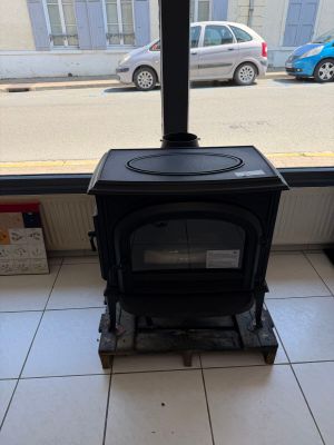 a black stove sitting in front of a window in a room