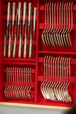 many forks and spoons in a red box