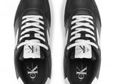 black and white sneakers with white laces and a monogram logo