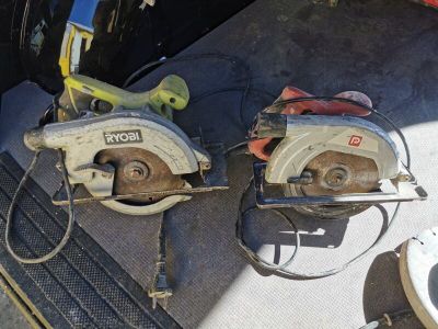 two circular saws sitting on the floor next to each other