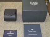 a watch and a wallet on a table in a hotel room