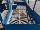 a blue truck with a metal basket on the back of it