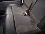 the back seat of a car with a bottle of soda in it