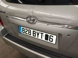 a silver car that has a number plate on it