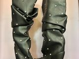 une paire de bottes en cuir noir ornées de clous argentés au talon
