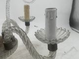 a glass candle holder with a rope attached to it