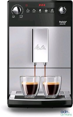 a close up of a coffee machine with two cups of coffee