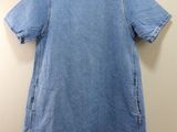 the back of a blue denim dress hanging on a hanger