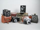 a lot of different types of cameras on the table