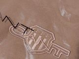 a brown t - shirt with a logo on it
