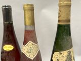 four bottles of wine are lined up on a table
