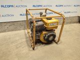 a small engine sitting on top of a cart in front of a wall