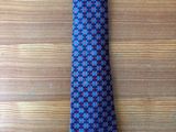 a blue and black tie on a wooden table