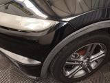 a close up of a black car with a white stripe
