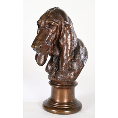 a bronze statue of a basset hound dog on a pedestal