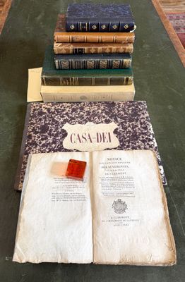 several books are stacked on top of each other on a table