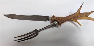 a knife and fork with antlers attached to it