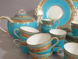 a lot of tea cups and saucers that are sitting on a table
