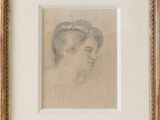 un dessin représentant la tête d'une femme dans un cadre doré