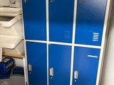 two blue lockers in the corner of a room