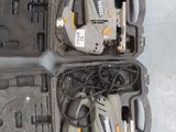 two electric tools are in a case on a table