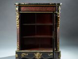 a black and gold decorated bookcase with a red and gold decoration
