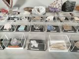 many different types of rocks and minerals in a display case