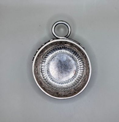 a silver plate with a circular design on it