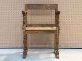 a wooden chair that is sitting in front of a wall