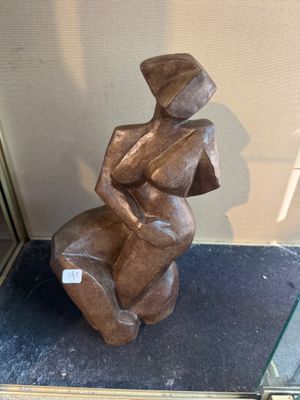 a statue of a woman sitting on top of a table