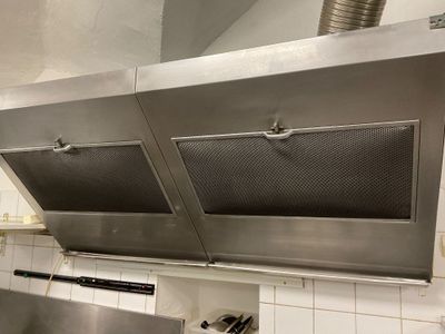 a large stainless steel stove top in a kitchen