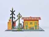 a small model of a train station with a red light