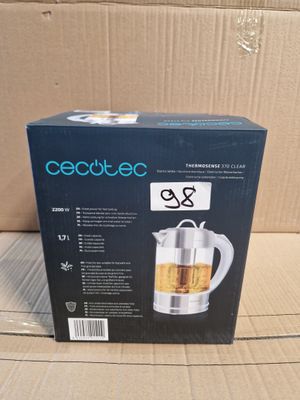 the box of a tea kettle is sitting on a cardboard box