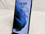 a close up of the back of a black phone on a white surface