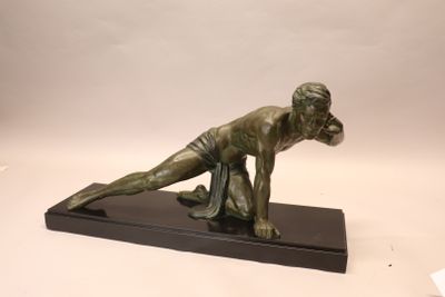bronze statue of a woman bending over on a black base