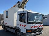 a white truck with a crane on the back of it