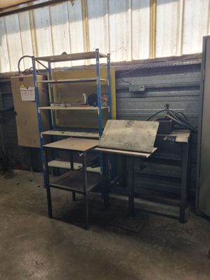 a room with a desk and shelves in it