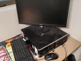 a desk with a computer, keyboard, and mouse on it
