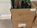 a cardboard box with a bunch of plants inside of it