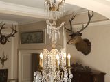 a chandelier hanging from the ceiling in a living room