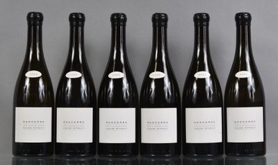 six bottles of wine lined up in a row on a table