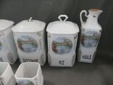 five white vases and a pitcher sitting on a table