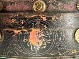 a close up of a black and gold box on a table