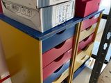 boxes stacked on top of each other on a shelf in a room