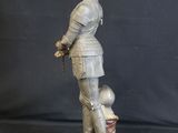 statue of a woman in a suit with a dog on a pedestal